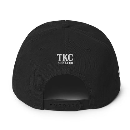 Back of black Christian hat with TKC Supply Co. logo above snap