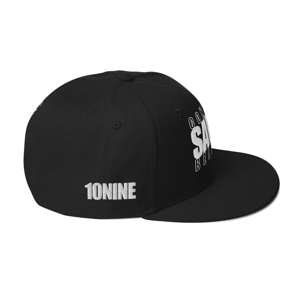 Side view of black snapback hat with 10NINE logo on right panel