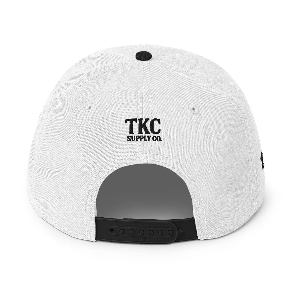 Back of black and white Christian hat with TKC Supply Co. logo above snap