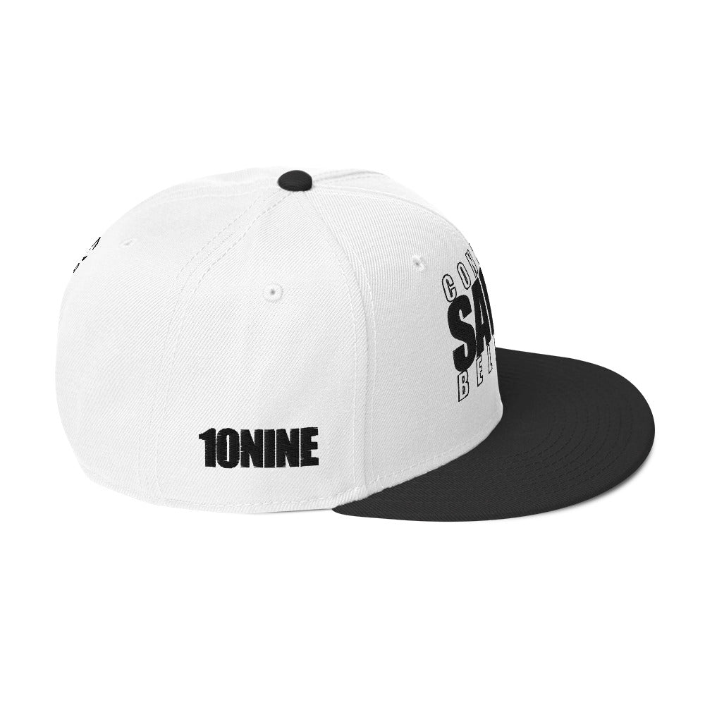 Side view of black and white snapback hat with 10NINE logo on right panel